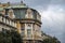 Beautiful, classic, old house with bright yellow facade with stone ornaments and green cooper roof in the city of Rijeka