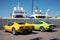 beautiful classic sports cars De Tomaso Pantera GTS yellow and a lime Datsun 240Z parked in the port