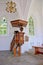 beautiful classic wooden pulpit in old church with gothic windows