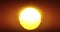 Beautiful Clear Big Sunrise or Sunset Close-up Looped Animation. Big Red Hot Sun in Warm Air Distortion Above Horizon