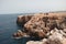 Beautiful cliff in Menorca with reddish stone