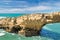 Beautiful cliffs on atlantic coastline with turquoise ocean wave erosion caves background in vivid colors in biarritz, basque cou