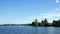 Beautiful clip from a moving boat of a lake in Minnesota with blue sky and water and a boat dock.