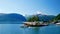 Beautiful clip of a pleasure boat leaving a marina in Valldal, Norway and heading into the calm waters of a fjord on a sunny day