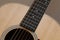 Beautiful close up abstract picture of a classical acoustic guitar with soft light brown beige natural wood grain, ebony fretboard
