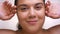 Beautiful close-up clean skin of caucasian overweight girl touching her skin with joy in white studio