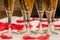 Beautiful closeup of champagne glasses and red rose petals