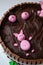 Beautiful closeup of a chocolate cake with a design of pigsty with swines