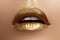 Beautiful closeup with female plump lips with gold color makeup. Fashion celebrate make-up, glitter cosmetic