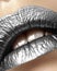 Beautiful closeup with female plump lips with silver color makeup. Christmas celebrate make-up, glitter sparkles on lip