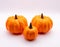 Beautiful closeup shot of three marbled pumpkins against a white background