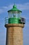 Beautiful closeup vertial evening view of green West Pier lighthouse in Dun Laoghaire harbor, Dublin, Ireland. Top of lighthouse