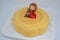 Beautiful closeup of yellow mousse cake with chocolate girl and dog. Delicious cake. Sweet dessert