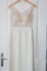 Beautiful clothing dress for bride in salon hang in wood door