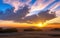 Beautiful cloud formation scenery during the sunrise on the empty field