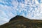 Beautiful clouds above Platafjellet in summer. Rocky hills with some vegetation. Photo taken at midnight, scene