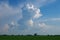 Beautiful clouds against a blue sky background. White cloud sky. Blue sky with cloudy weather, nature cloudiness over green field.