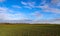 Beautiful clouds in a blue sky over a northern european agricutural field