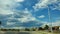 Beautiful cloudscape, breathtaking white clouds in blue sky over rural road