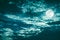 Beautiful cloudscape of night sky with dark cloudy. Some clouds overshadow the full moon. Serenity nature background in nighttime