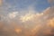 Beautiful cloudscape with orange and gray tones and blue sky at sundown