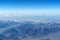 Beautiful cloudscape and snow mountains from plane window