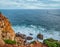 Beautiful cloudy sky and foaming waves approaching rocky shore of the Atlantic ocean. Beautiful nature background of Portugal