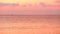 Beautiful cloudy sunset with beautiful pink reflection on the sea surface,