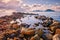 Beautiful coastal sunset with breakwater groynes in the foreground on the Aegean sea