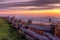 Beautiful coastal sunset over a fence