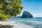 Beautiful coastline of El Nido, Palawan island, Philippines. Green foliage, remote beach and huge mountain in sea