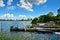 A beautiful coastline at a lake in Germany, Schlei, with a tiny boat at a pier in front of beautiful blue sky and white clouds