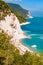 Beautiful coastline of Numana, Ancona, Italy surrounded by high massive white limestone rocky cliffs eroded by Adriatic sea waves
