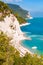 Beautiful coastline of Numana, Ancona, Italy surrounded by high massive white limestone rocky cliffs eroded by Adriatic sea waves