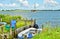 A beautiful coastline at the pierin Germany, Schlei, with a tiny boat at a pier in front of beautiful blue sky and white clouds