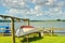 A beautiful coastline at the pierin Germany, Schlei, with a tiny boat at a pier in front of beautiful blue sky and white clouds