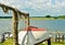 A beautiful coastline at the pierin Germany, Schlei, with a tiny boat at a pier in front of beautiful blue sky and white clouds