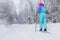 Beautiful cold forest view of ski run track on ski resort, winter day on a slope, pist, nordic skier on the track in winter,