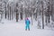 Beautiful cold forest view of ski run track on ski resort, winter day on a slope, pist, nordic skier on the track in winter,