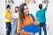 Beautiful colombian female student, with group of young adults at classroom