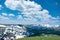 Beautiful Colorado spring landscape with green meadows and snow covered mountains.