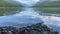 Beautiful colored rocks and pebbles on the shores of Bowman Lake in Glacier National Park Montana. Wide angle view