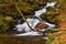 Beautiful colorful background with river and stones in autumn time. White Opava Waterfalls - Jeseniky Mountains - Czech Republic