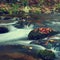 Beautiful colorful background with river and stones in autumn time. White Opava Waterfalls - Jeseniky Mountains - Czech Republic