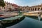 A beautiful and colorful canal in italy with nice facade of houses and old boats