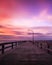 Beautiful colorful clouds streaking over a pier at sunset. Jones Beach - Long Island New York.