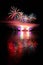 Beautiful colorful fireworks on the water surface. Night scene. Concept for holidays and celebrations