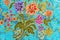 Beautiful colorful flowers on batik background