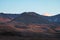 Beautiful colorful grassland mountain with blue sky at sunset. I