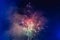 Beautiful colorful holiday fireworks in the evening sky with majestic clouds